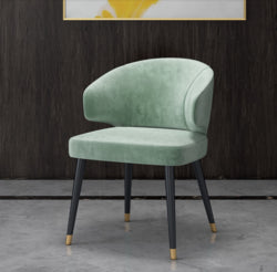 Colorful velvet dining chair with blue seat and black metal legs.