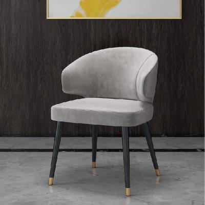 Colorful velvet dining chair with blue seat and black metal legs.
