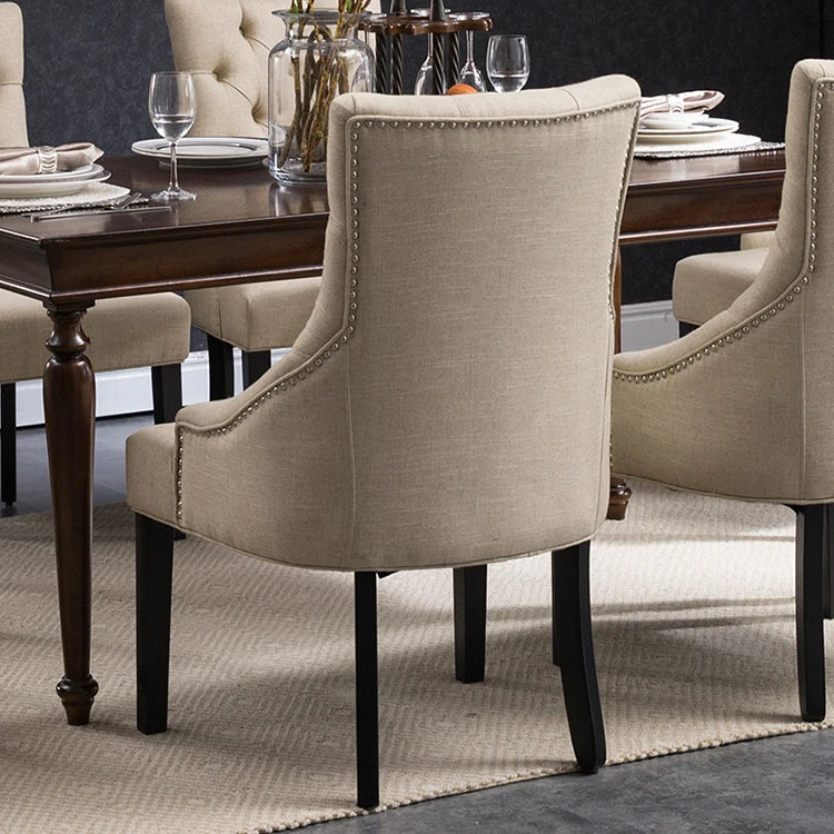 Luxury velvet dining chair with solid wood frame and tufted button design.