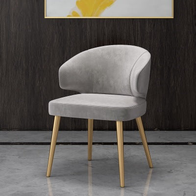 Colorful velvet dining chair with blue seat and black metal legs.