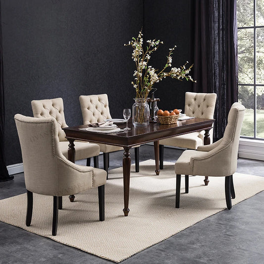 Luxury velvet dining chair with solid wood frame and tufted button design.