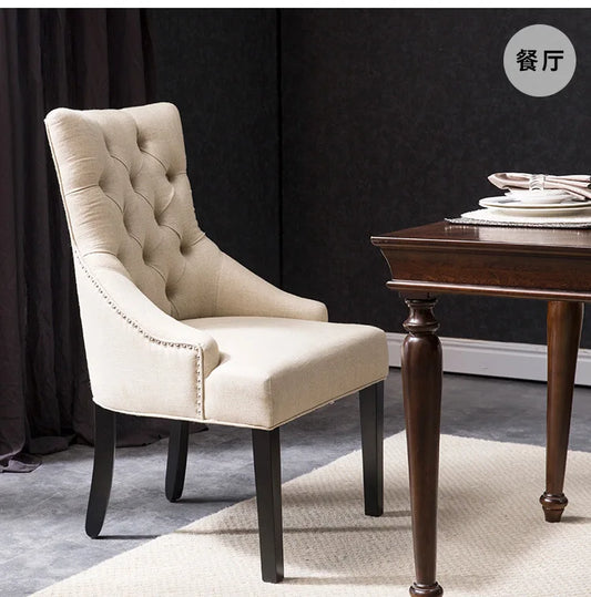 Luxury velvet dining chair with solid wood frame and tufted button design.