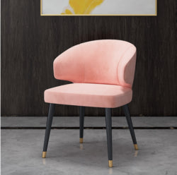 Colorful velvet dining chair with blue seat and black metal legs.