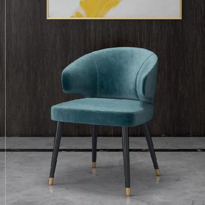 Colorful velvet dining chair with blue seat and black metal legs.